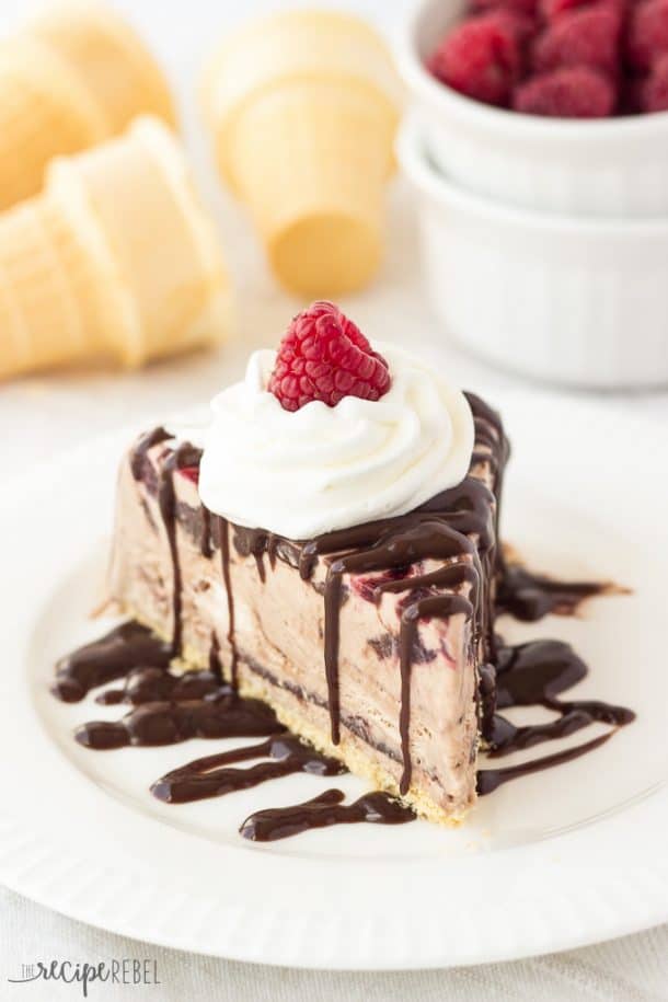 piece of nutella raspberry ice cream cake on white plate topped with whipped cream and one raspberry
