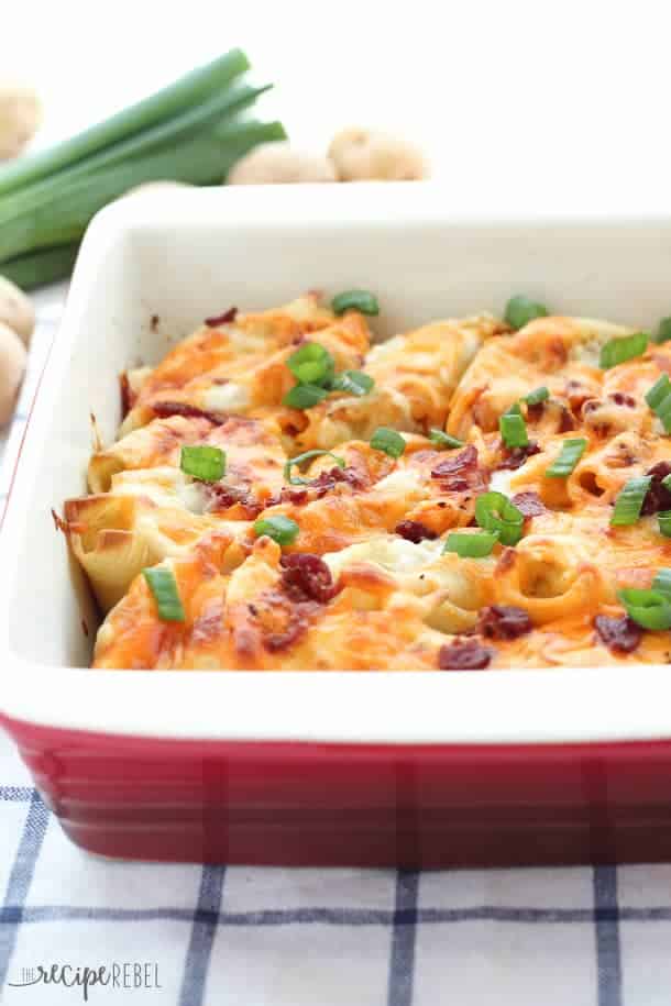 close up of perogy stuffed shells in ceramic baking dish