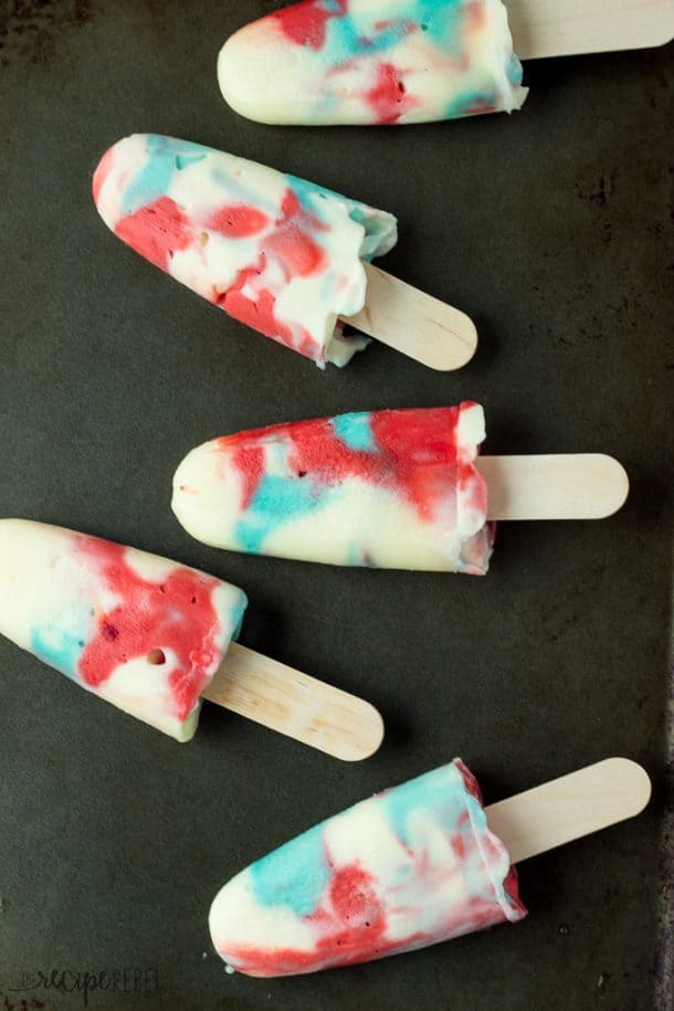 overhead image of pudding pops on black background with wooden popsicle sticks