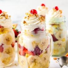 banana split trifle in mason jar with whipped cream