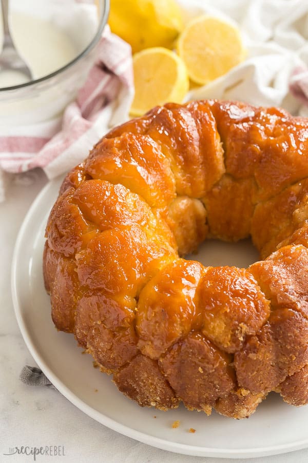 This Glazed Lemon Monkey Bread is made with homemade bun dough rolled in lemon sugar, baked, and covered in a thick lemon glaze. The perfect make ahead breakfast, brunch or dessert! #lemon #bread #breakfast #baking lemon monkey bread no glaze