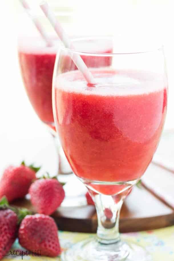 two glasses of two ingredient slush with fresh strawberries on the side