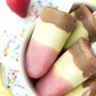 Banana Split Pudding Popsicles: 3 layers of creamy, frozen pudding: strawberry, banana pineapple and chocolate! The easy way to enjoy a banana split this summer! www.thereciperebel.com