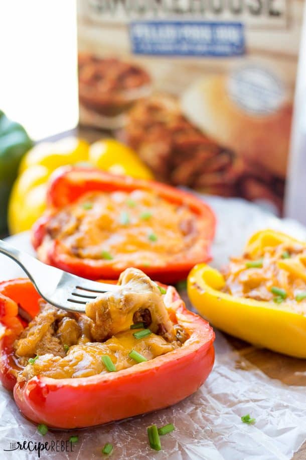 Grilled Pulled Pork Stuffed Peppers! Sweet bell peppers stuffed with sweet, smoky, tender pulled pork and cheddar cheese and grilled to perfection! Wrap them in tin foil and theyโre great for making ahead or packing in a picnic. Only 3 ingredients! Can be made on the grill, in the oven or in the slow cooker. www.thereciperebel.com fork scooping pulled pork and cheese out of a stuffed pepper