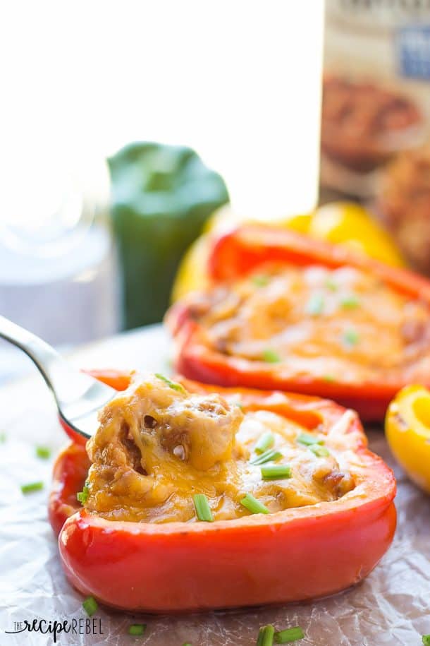 fork scooping pulled pork out of stuffed pepper on parchment paper