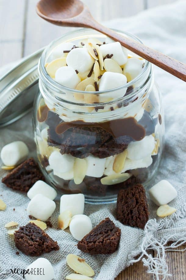 heavenly hash brownie trifle in small jar with mini marshmallows and sliced almonds