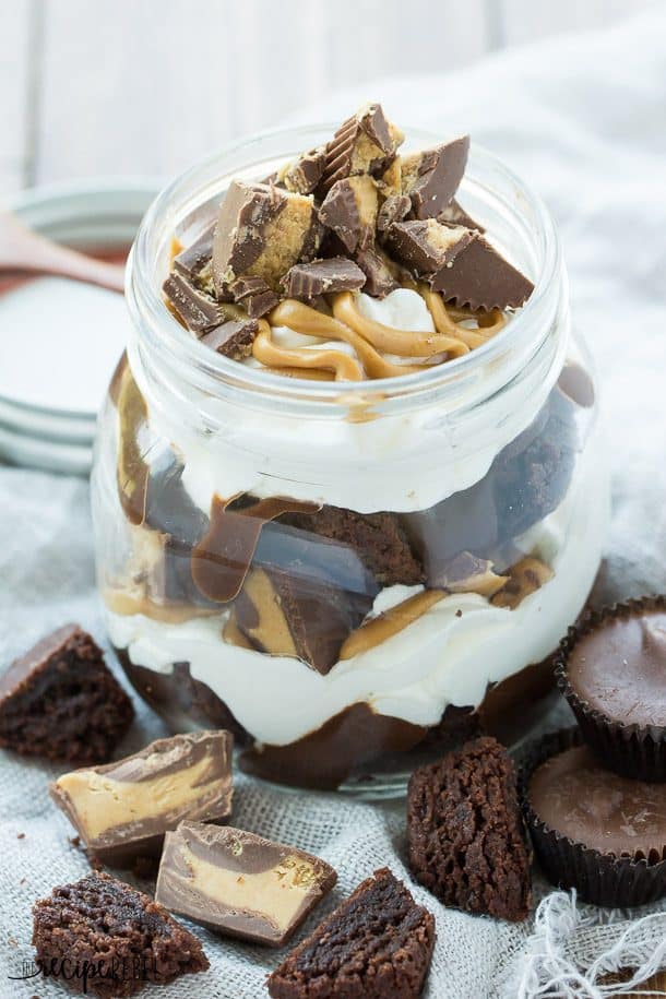 peanut butter cup brownie trifle in small jar layered with chocolate pudding and whipped topping