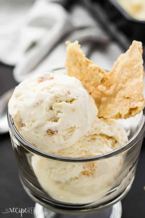 close up of scoops of coconut cream pie ice cream in bowl with chunks of pie crust