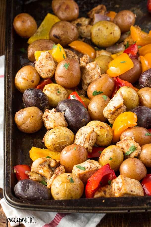 chicken fajita sheet pan dinner with peppers and potatoes close up on sheet pan