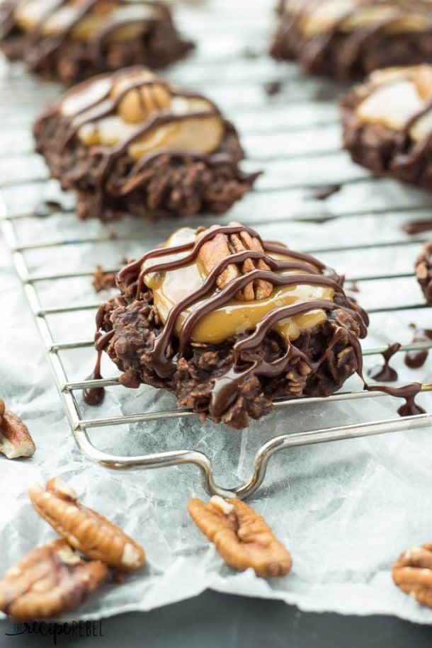 no bake turtle christmas cookies on cooling rack with caramel and chocolate drizzle with pecan halves