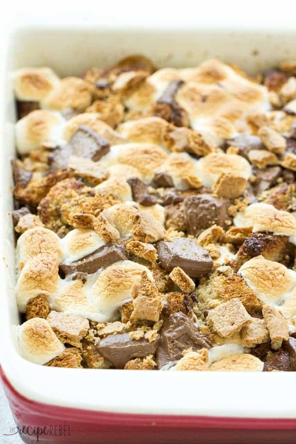 S'mores Overnight French Toast Casserole: An easy, overnight french toast casserole is topped with marshmallows, chocolate chunks and graham crackers and baked until irresistibly gooey -- the perfect breakfast, brunch or brinner to take you from summer right through back to school! Only 8 ingredients! www.thereciperebel.com smores french toast casserole whole with toasted marshmallows chocolate squares and graham crackers
