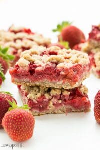 Strawberry Rhubarb Crisp Bars: Oatmeal cookie base topped with sweet and tangy strawberries and rhubarb topped with more oatmeal cookie topping -- your favorite summer dessert is now a portable treat or back to school snack! www.thereciperebel.com