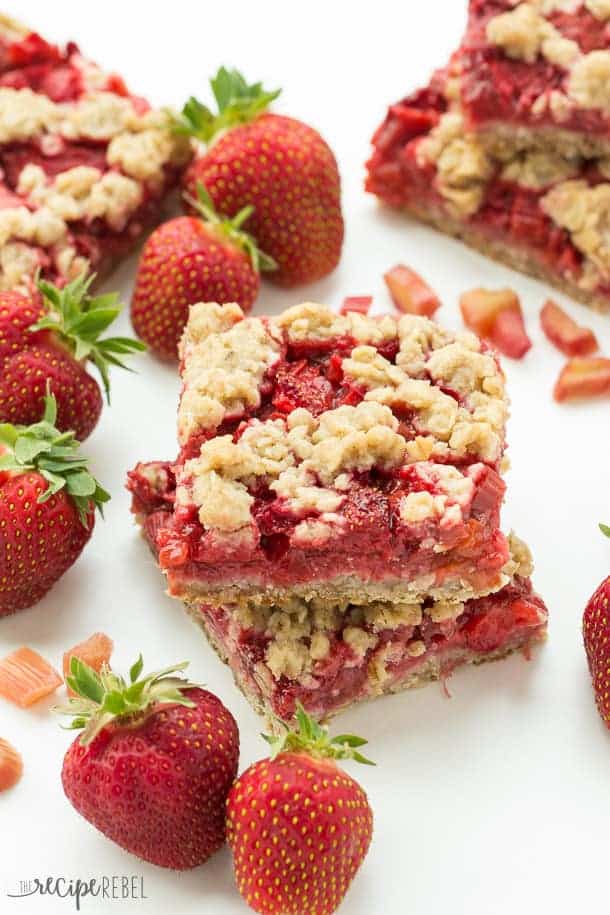 two strawberry rhubarb crisp bars stacked from above with more bars around