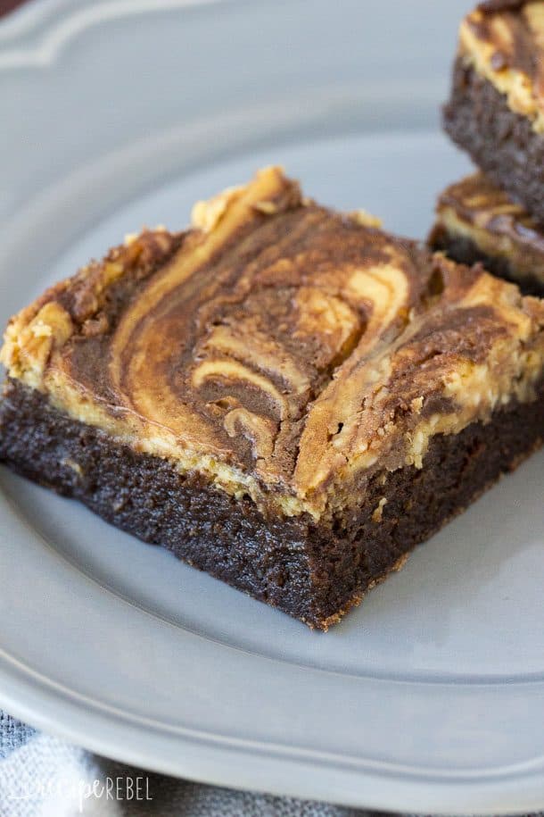 close up view of pumpkin cheesecake swirled top of brownie piece