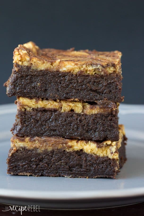 stack of three flourless pumpkin cheesecake brownies on grey plate