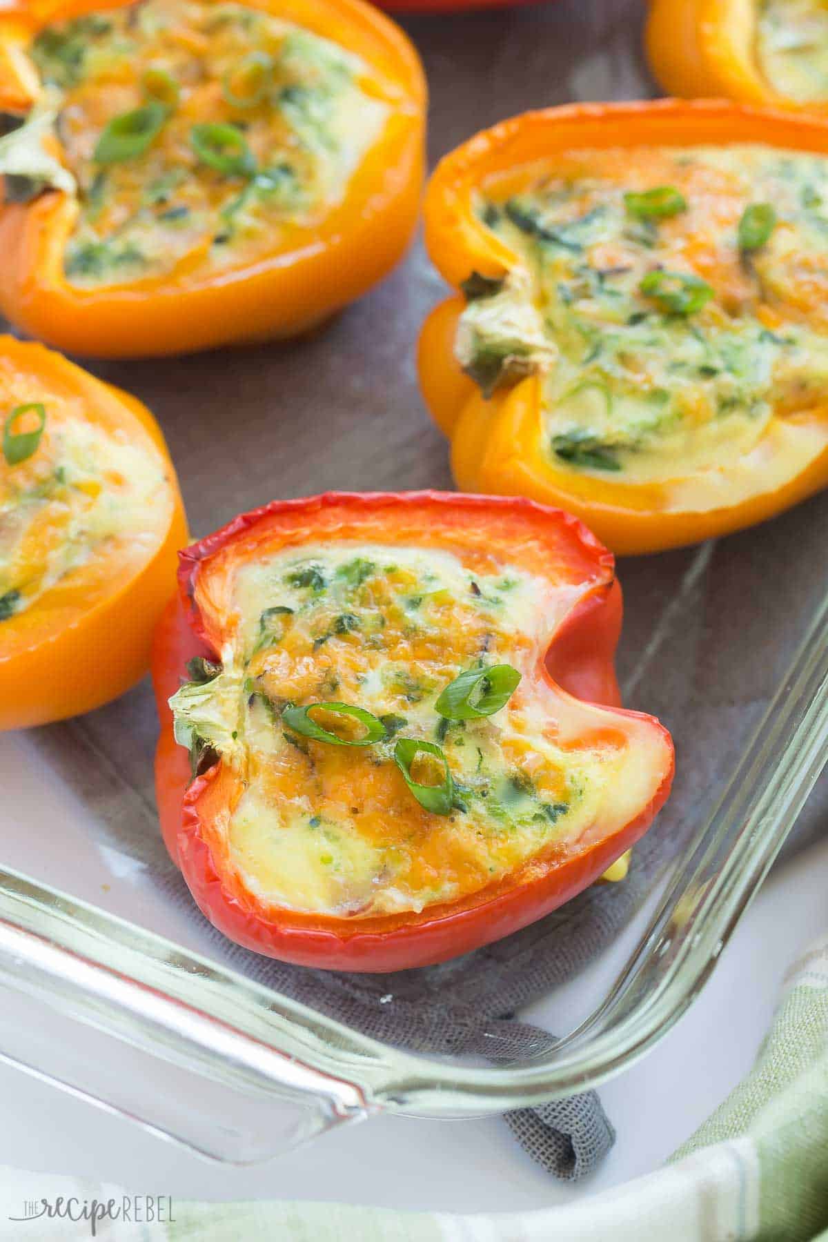 breakfast stuffed peppers in glass baking dish topped with green onions