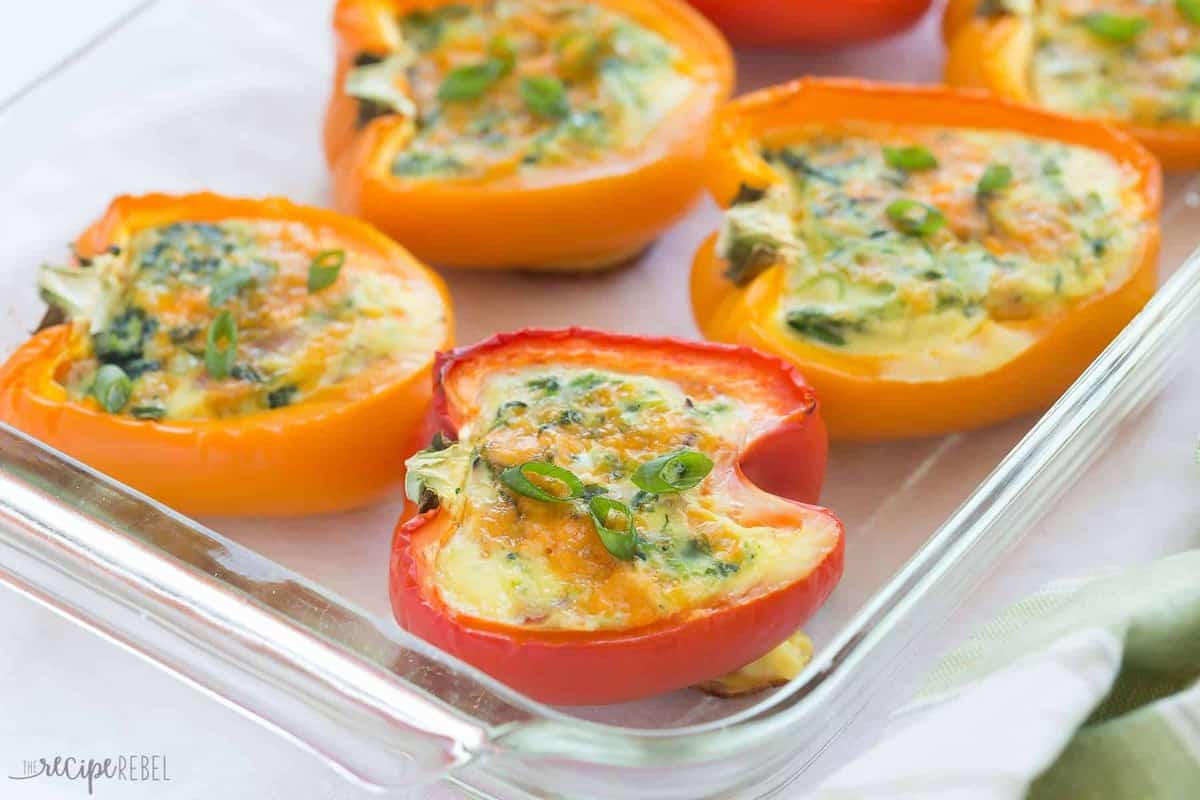 breakfast stuffed red and orange peppers in baking dish