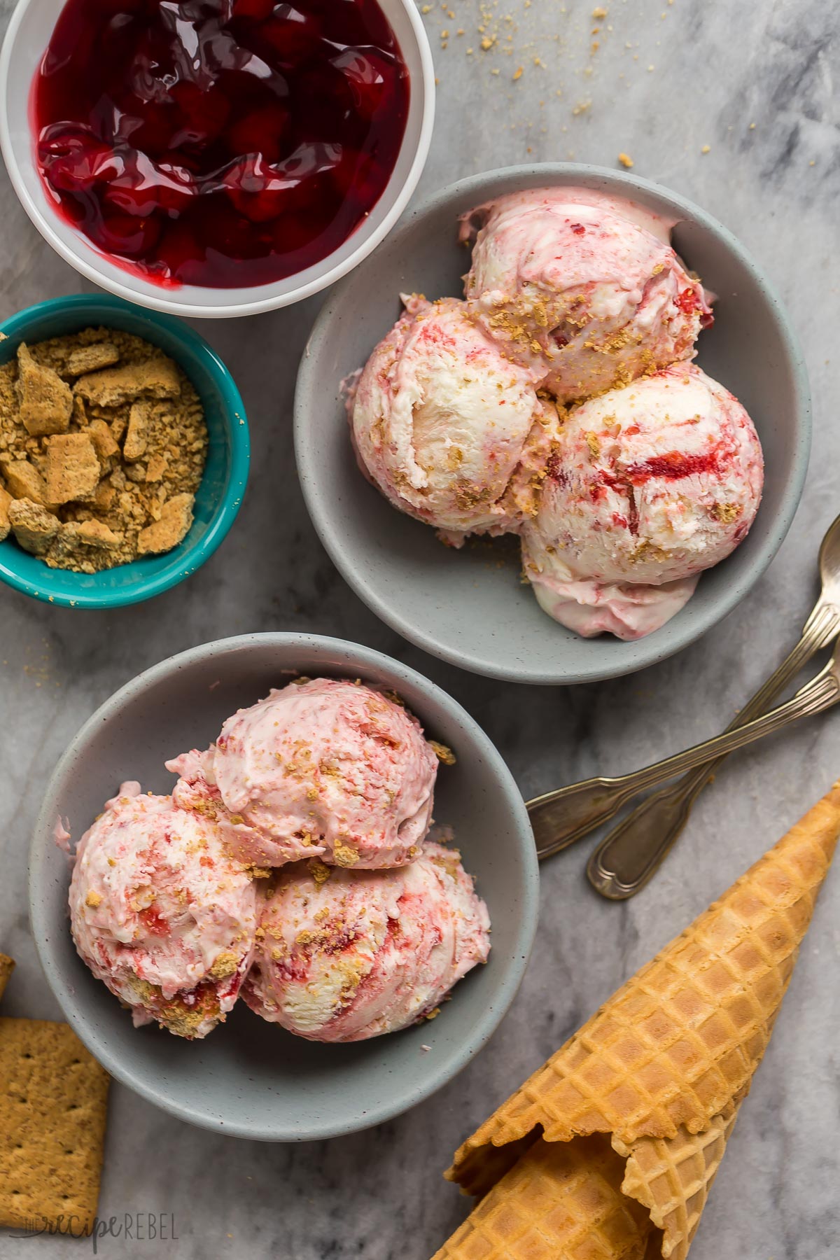 Smooth, creamy No Churn Cherry Cheesecake Ice Cream made with only 5 ingredients! Mix up the pie filling flavor to easily customize. #icecream #dessert | cherry cheesecake | cherry pie filling two bowls of no churn ice cream on marble background