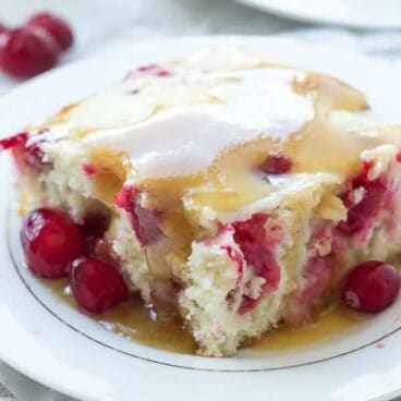 A soft, vanilla cake, loaded with cranberries topped with warm caramel sauce -- an impressive holiday dessert that is so much easier than it looks!