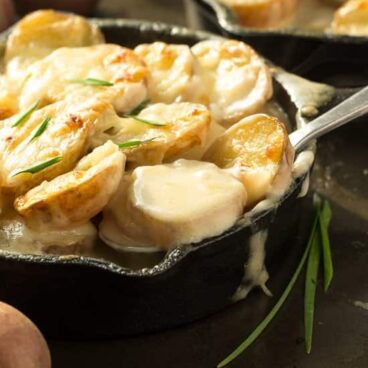 The best and easiest scalloped potatoes -- they're cooked completely in one skillet so there's no boiling the potatoes or cooking the sauce separately!