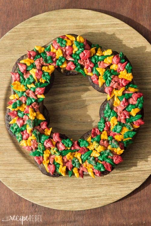 chocolate cupcakes in a circle decorated with frosting leaves in fall colors to form a wreath