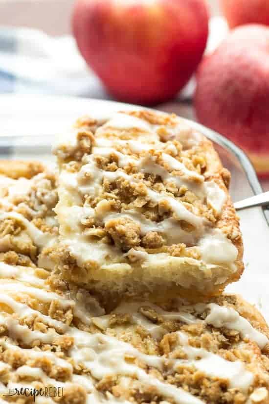 close up image of one apple crisp cinnamon bun topped with streusel and glaze