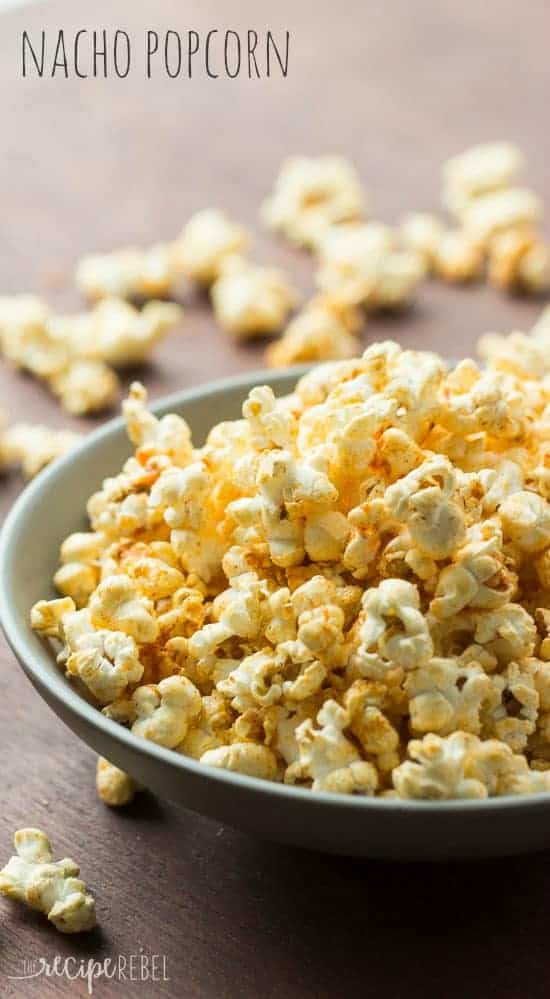 grey bowl full of popcorn with homemade nacho seasoning on a dark background