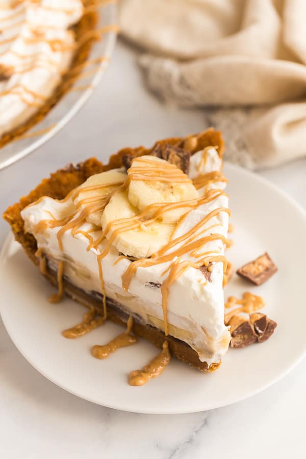 slice of chocolate peanut butter banana cream pie on plate