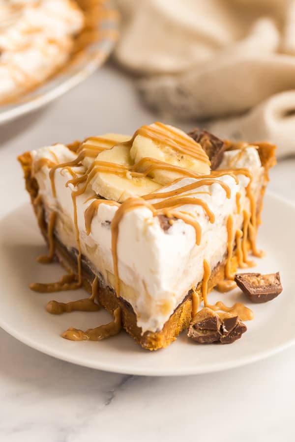 slice of banana cream pie with peanut butter drizzle