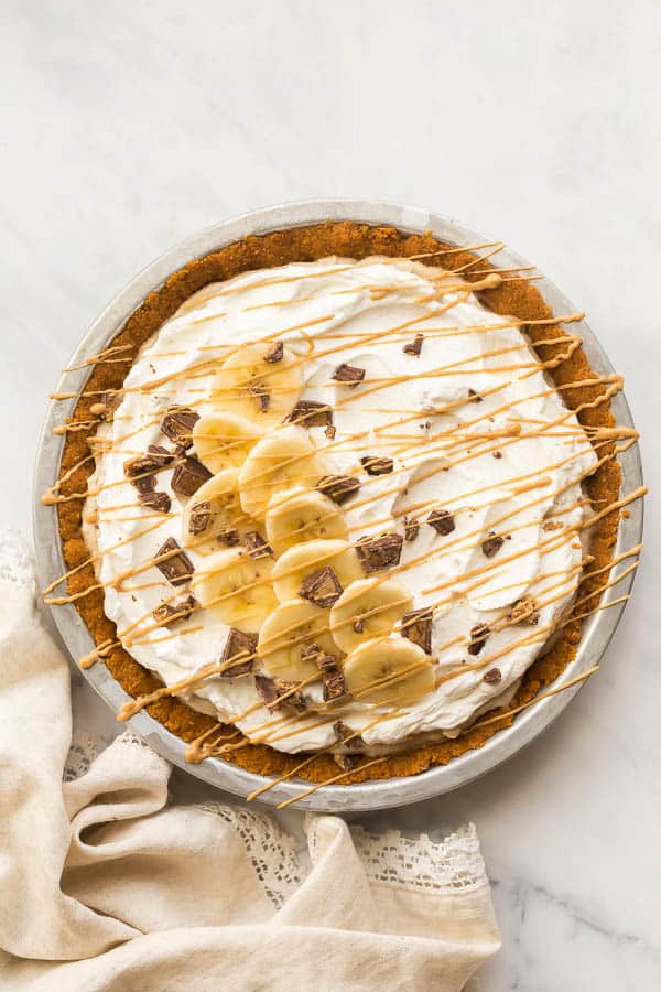 overhead image of no bake banana cream pie with peanut butter drizzle