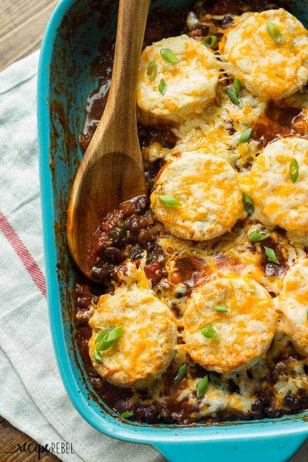 overhead image of blue baking dish with chili in the bottom and cheesy biscuits on top