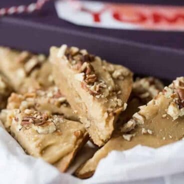 Dense, chewy blondies loaded with pecans and topped with a brown sugar glaze and chopped pecans -- the perfect holiday bar for Christmas or Thanksgiving!