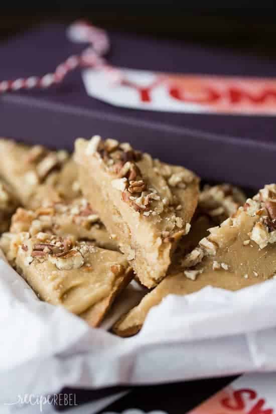 brown sugar pecan blondies cut in triangles and stored in a purple gift box with tissue