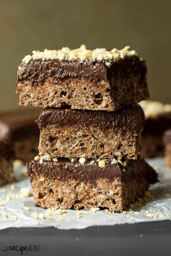 A simple yet decadent and impressive treat to add to your holiday baking platter! Because no bake is always better :) stack of three chocolate truffle rice krispie treats topped with chopped peanuts