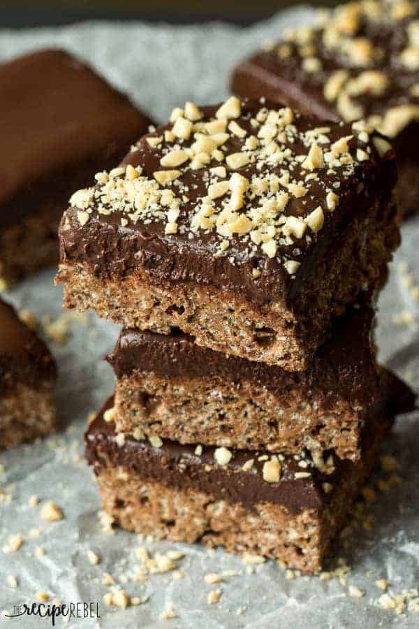 stack of three chocolate rice krispie treats topped with crushed peanuts close up