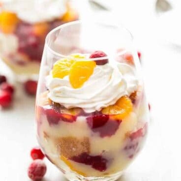 Vanilla cake, vanilla pudding, oranges and cranberry sauce layered together for the perfect holiday dessert -- this Cranberry Orange Trifle is great for potlucks!