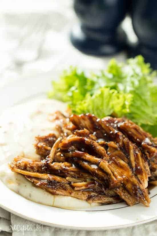 close up image of turkey breast with apricot balsamic glaze on mashed potatoes on a white plate