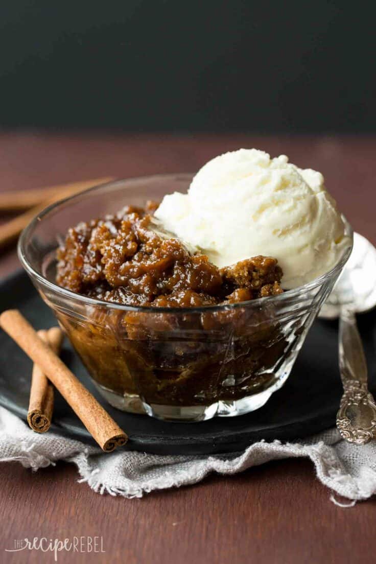 glass bowl of gingerbread pudding cake with ice cream on top.