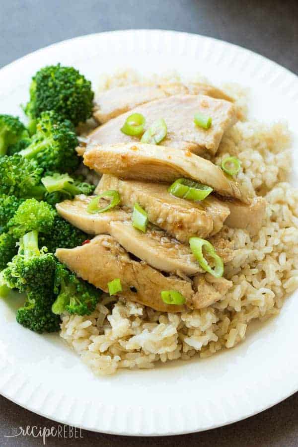 overhead image of sliced coconut chicken breasts on rice with broccoli