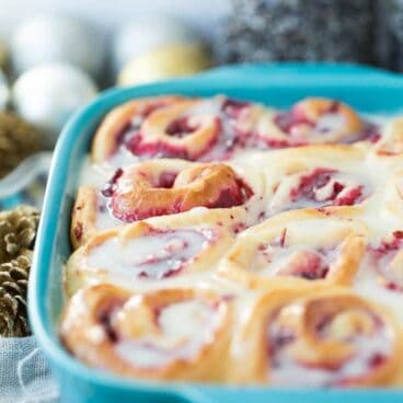 Soft, homemade bun dough filled with easy homemade cranberry filling (or sub store bought), topped with a white chocolate glaze -- perfect for Christmas brunch or a make ahead weekend breakfast!