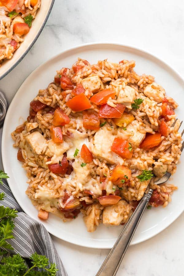 one pot chicken and rice on plate close up with tomatoes