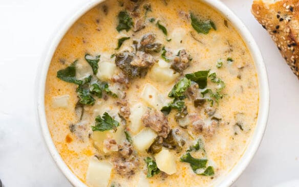 overhead image of one bowl of zuppa toscana with bread