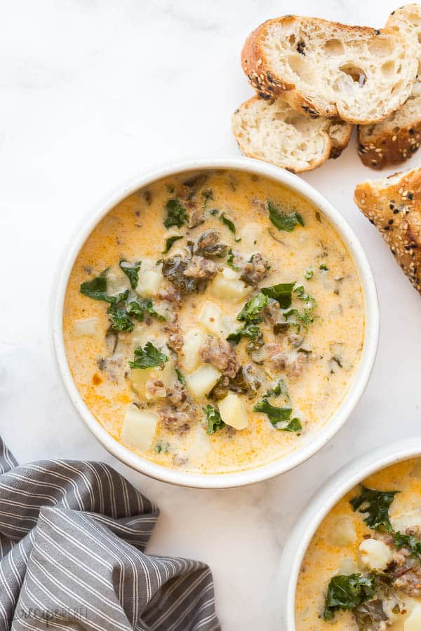 overhead image of one bowl of zuppa toscana with bread
