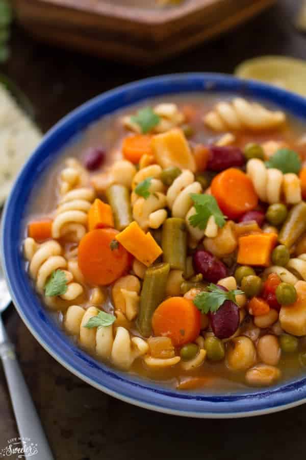 hearty vegetable soup with noodles carrots beans peas and squash