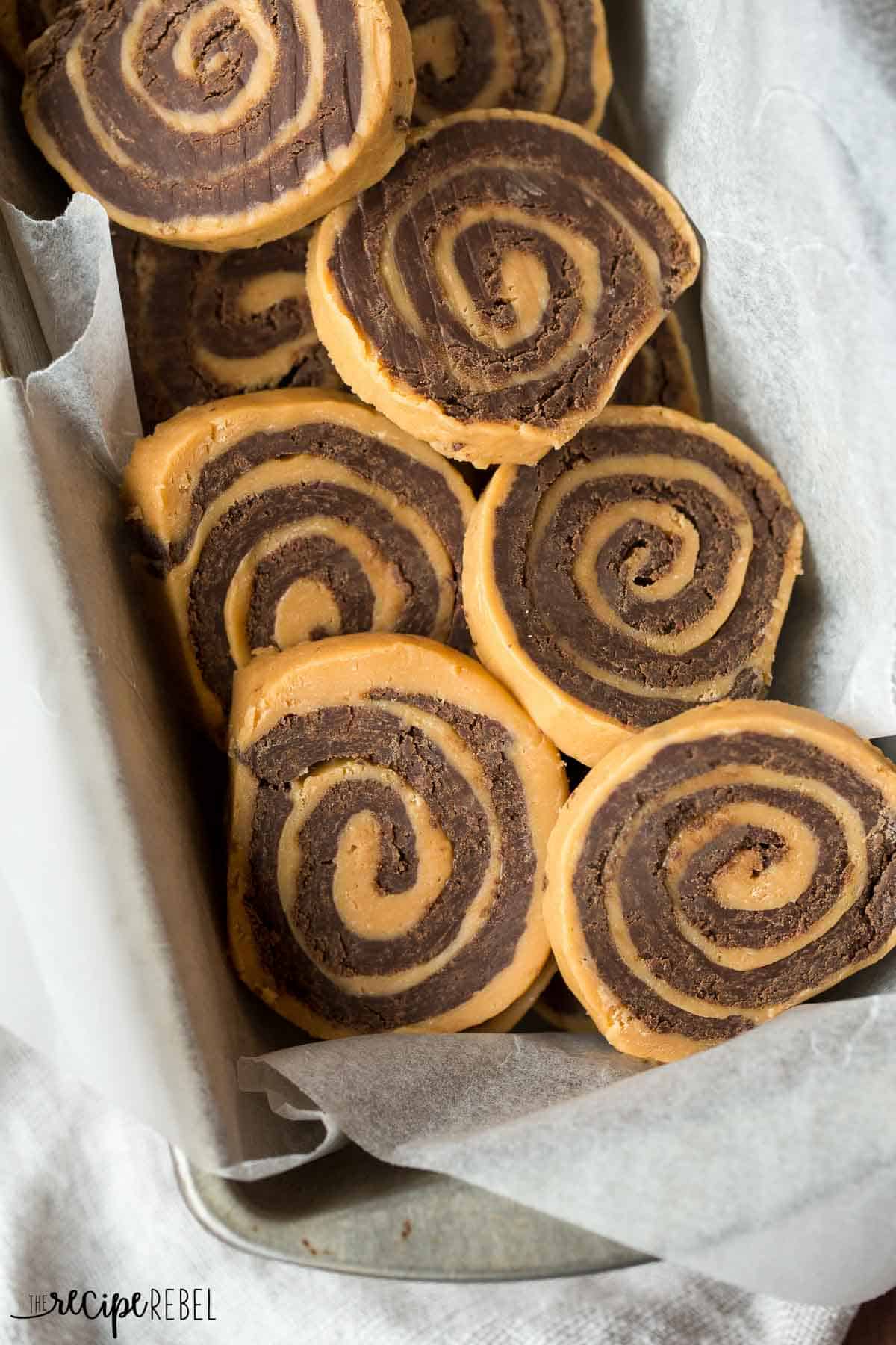 no bake chocolate peanut butter pinwheels close up overhead in a pan with parchment paper