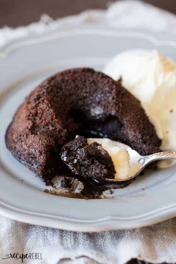 flourless chocolate cake with spoon taking a bite with ice cream