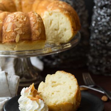 A rich, moist Almond Pound Cake that's made better for you with yogurt and reduced sugar! A fun New Years dessert with one whole almond baked in -- whoever gets the almond will have one year good luck!