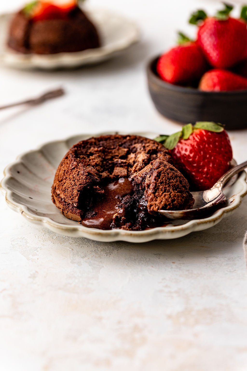 molten lava cake with ice cream on top open on plate.