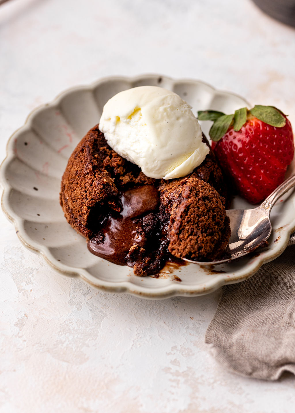 lava cake cut open with ice cream on top.