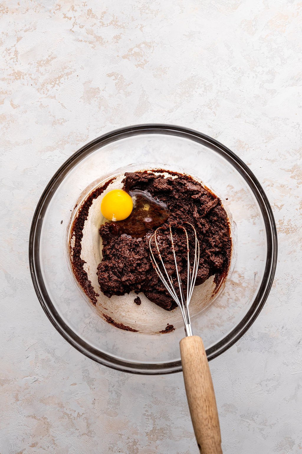 cocoa powder and egg being whisked into lava cake batter.